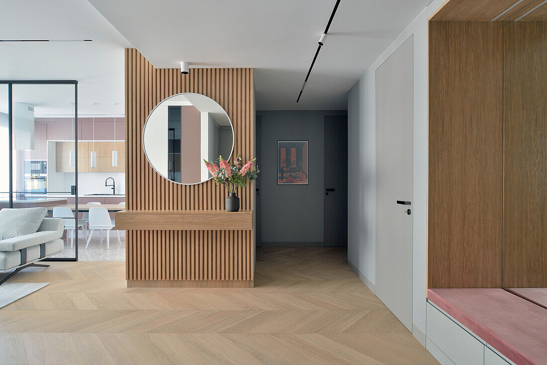 Modern home furnishings with wooden elements and round mirror, in Warsaw