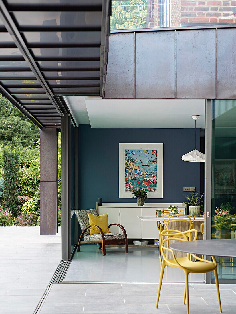 Terrace with yellow chairs and view into the living room, modern design