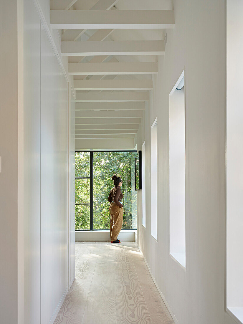 Bright hallway with exposed beams and view of the garden