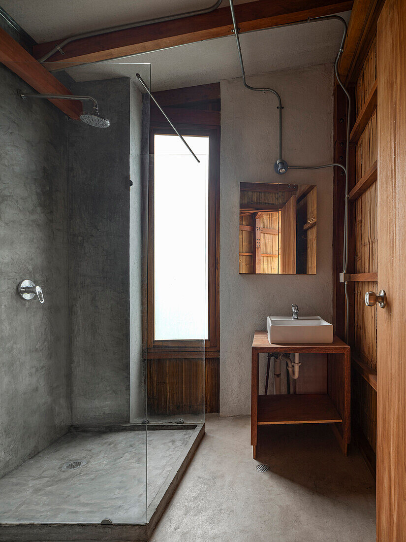 Bathroom with shower, washbasin and wooden elements, minimalist design