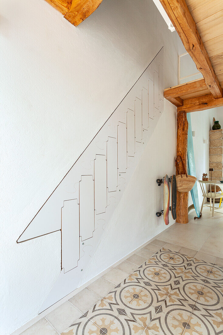 Room with fold-out staircase and patterned floor tiles