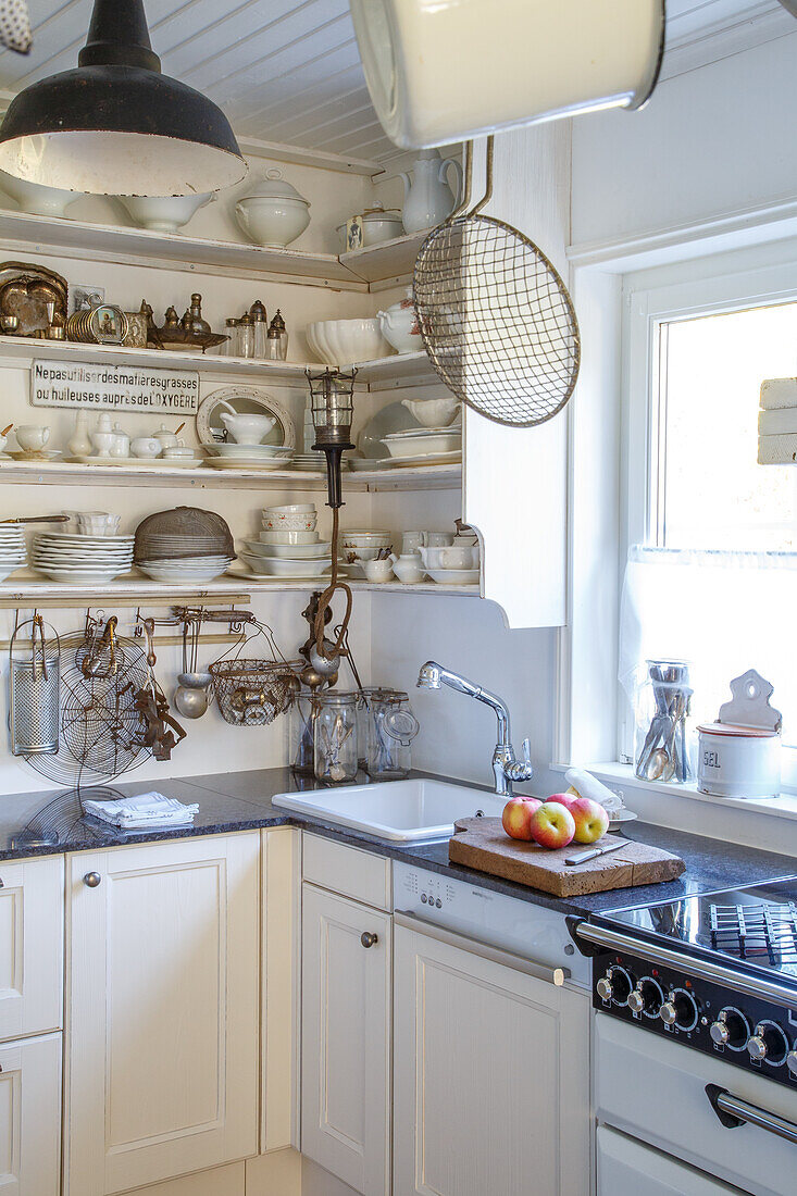 Bright kitchen with open shelves and white ceramic crockery