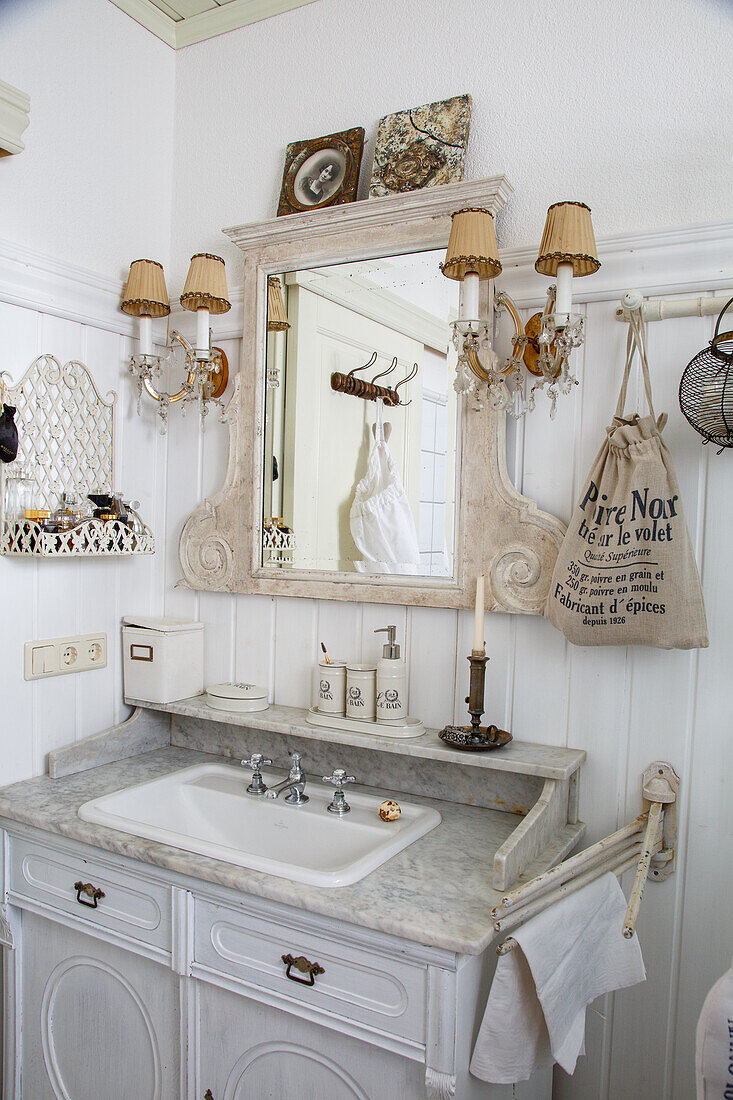 Nostalgic washbasin with marble top and vintage decorations in the bathroom