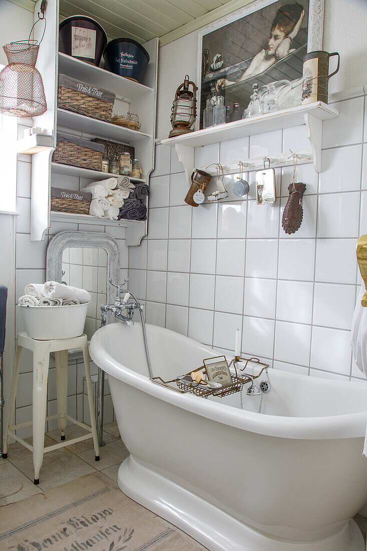 Vintage bathroom with freestanding bathtub and tiled wall