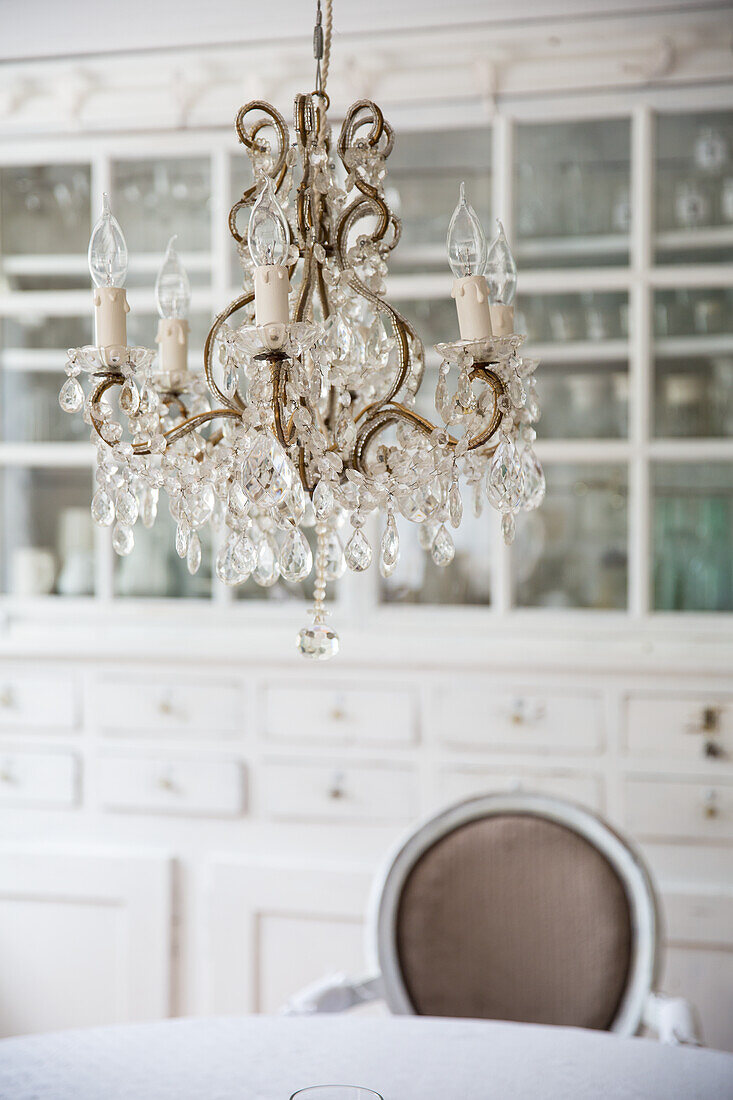 Crystal chandelier above round table in dining room