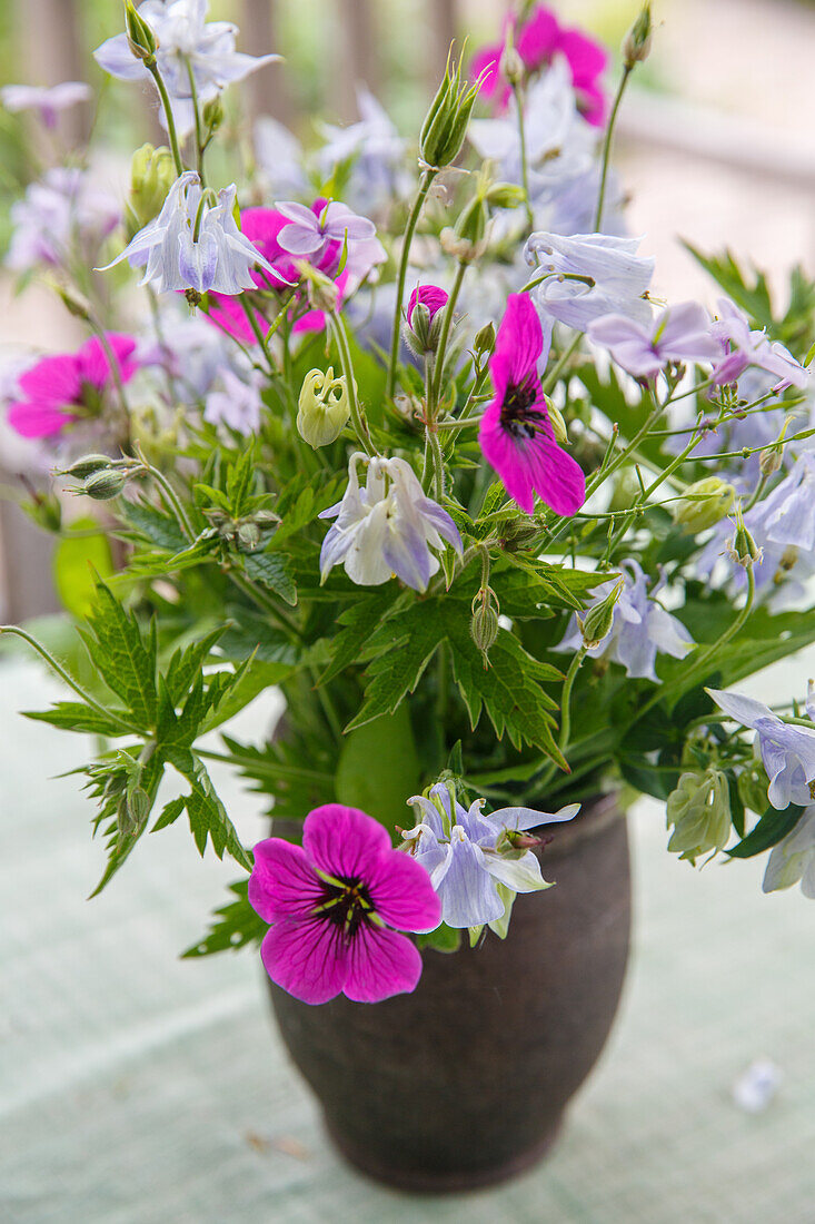 Colourful bouquet of summer flowers in ceramic vase