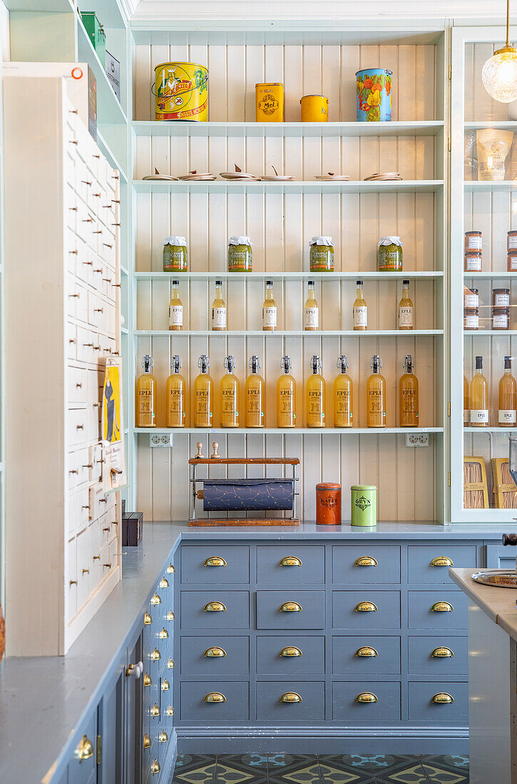 Sales room with blue drawers and shelves full of food