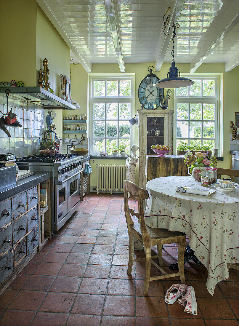 Country-style kitchen with gas oven and antique wooden furniture