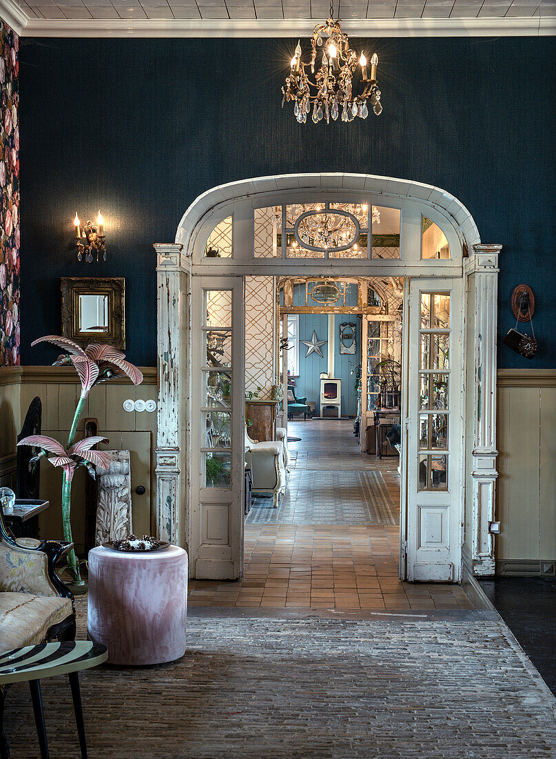 Antique entrance hall with chandelier and double-leaf door, view into living room