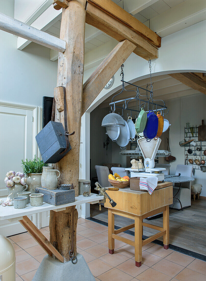 Country kitchen with rustic wooden beams and hanging pan rack