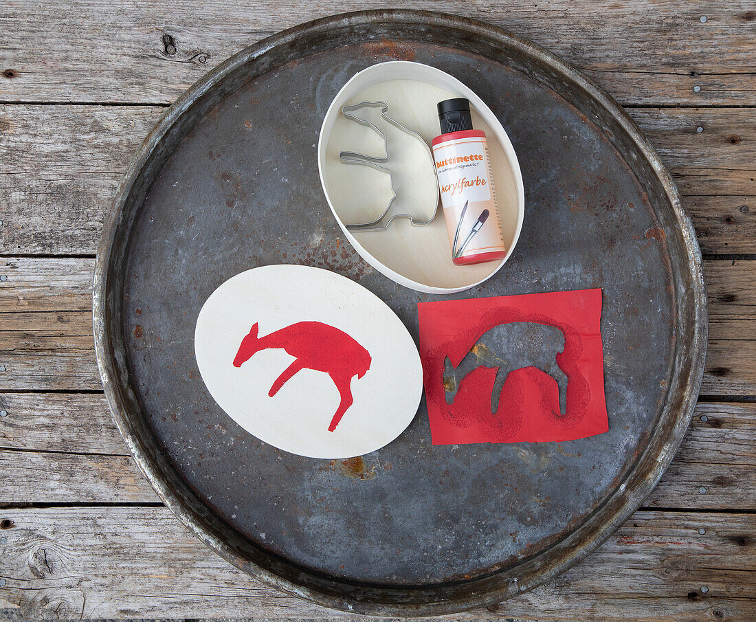 DIY stencils for animal silhouettes with paint tube on metal tray