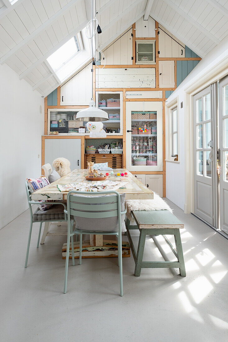 Dining area in pastel colours under sloping ceilings