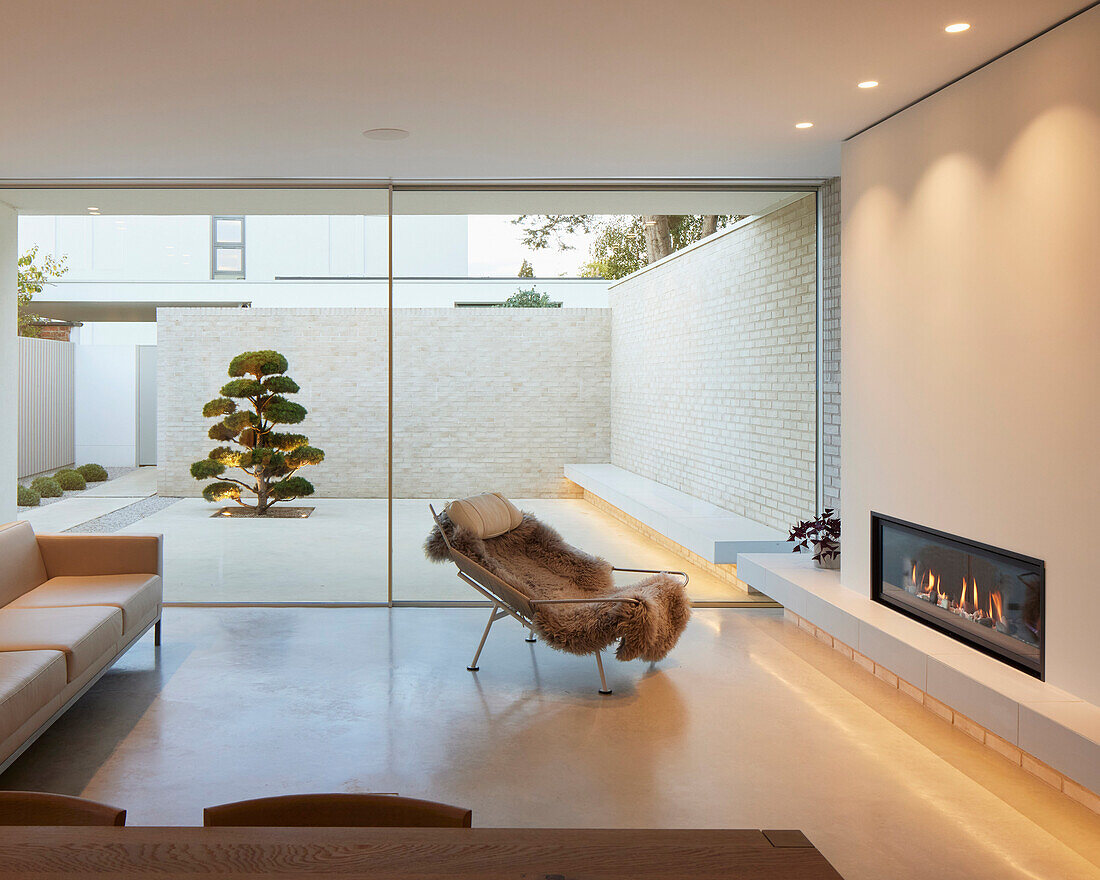 Modern living area with fireplace and view of the inner courtyard