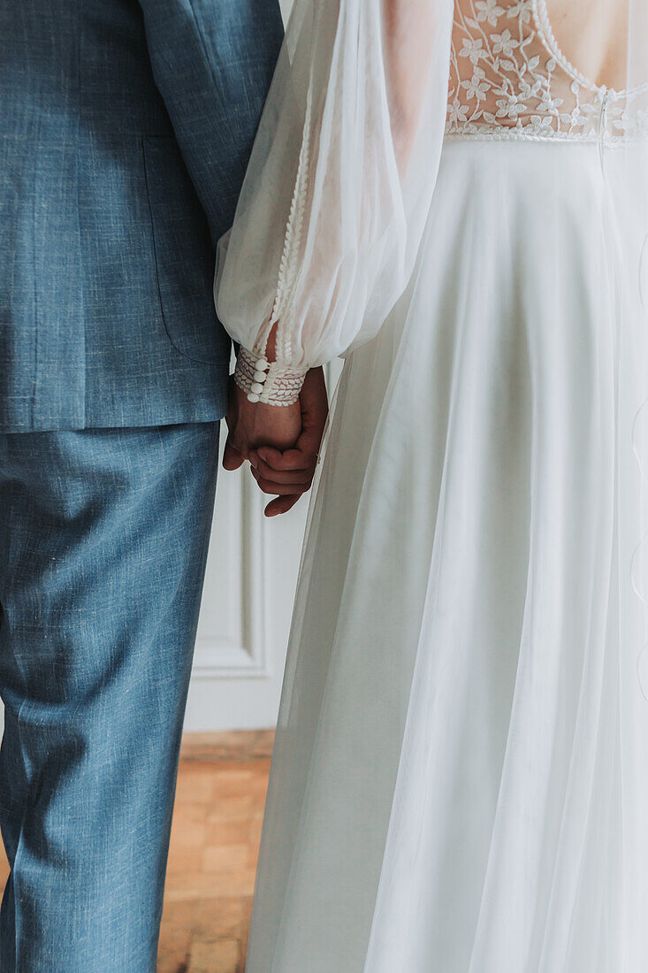 Bride and groom holding hands