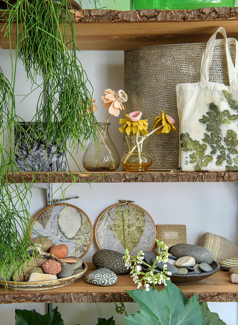 Decorative wall shelves with plants, fabric bag and natural stone collection