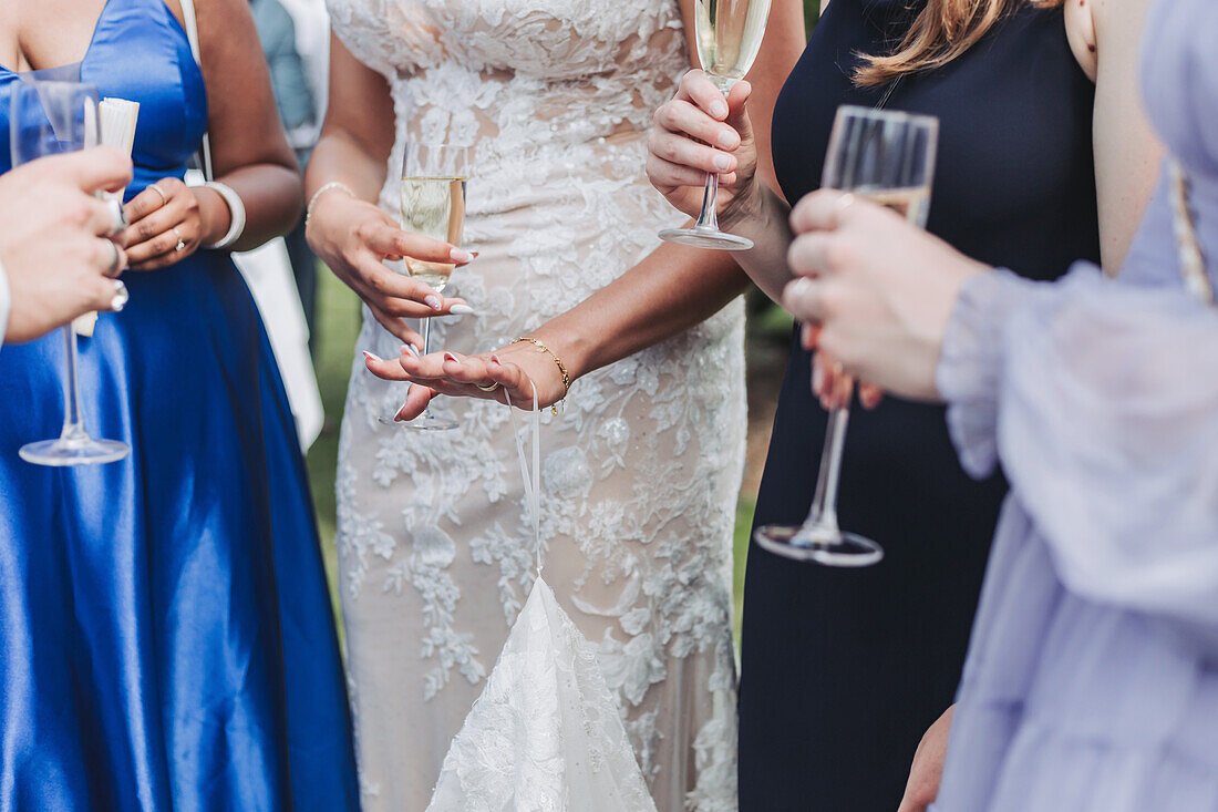 Group of people with champagne glasses at outdoor wedding party