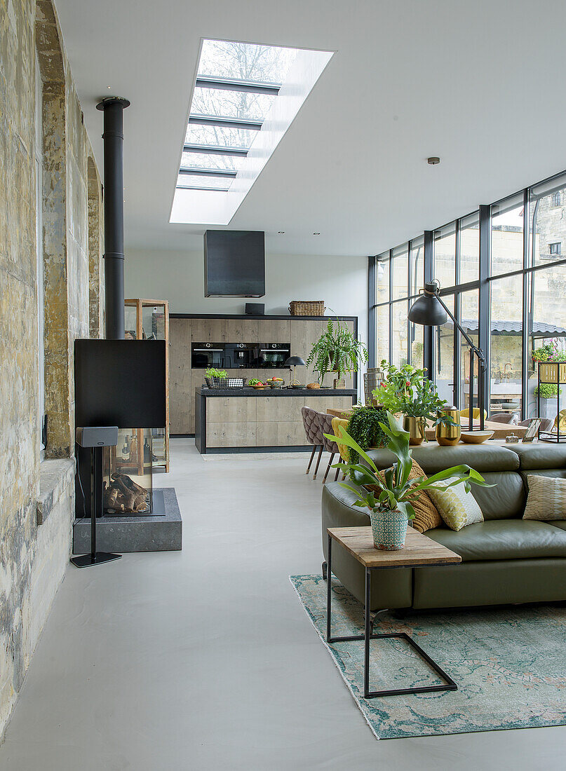 Open-plan living and dining area with panoramic windows and skylight