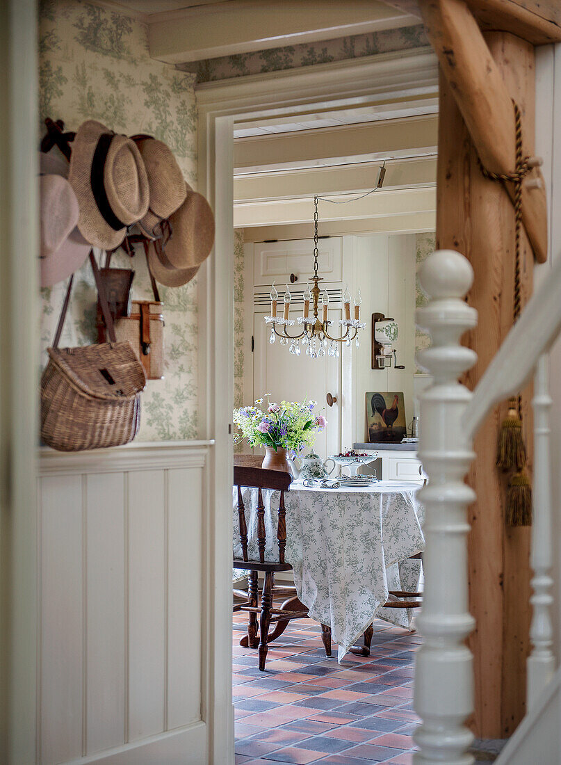 View from hallway to dining room with tablecloth and chandelier