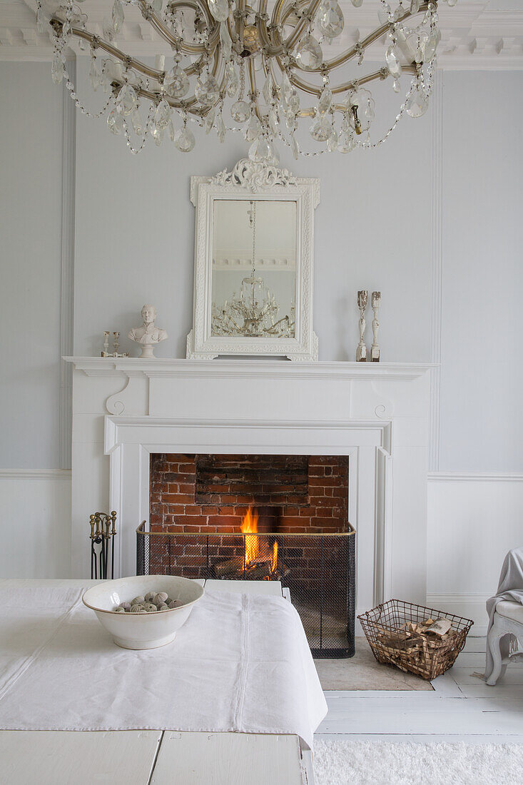 Room with fireplace, crystal chandelier and white furniture