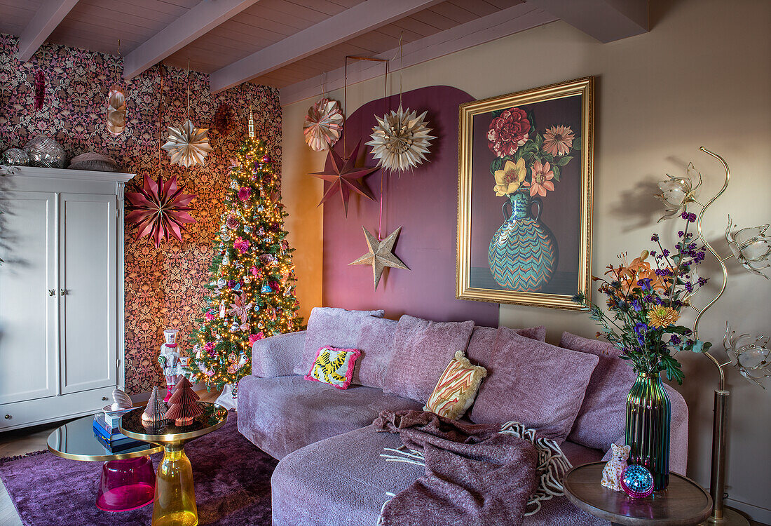 Living room with festively decorated tree and patterned wallpaper