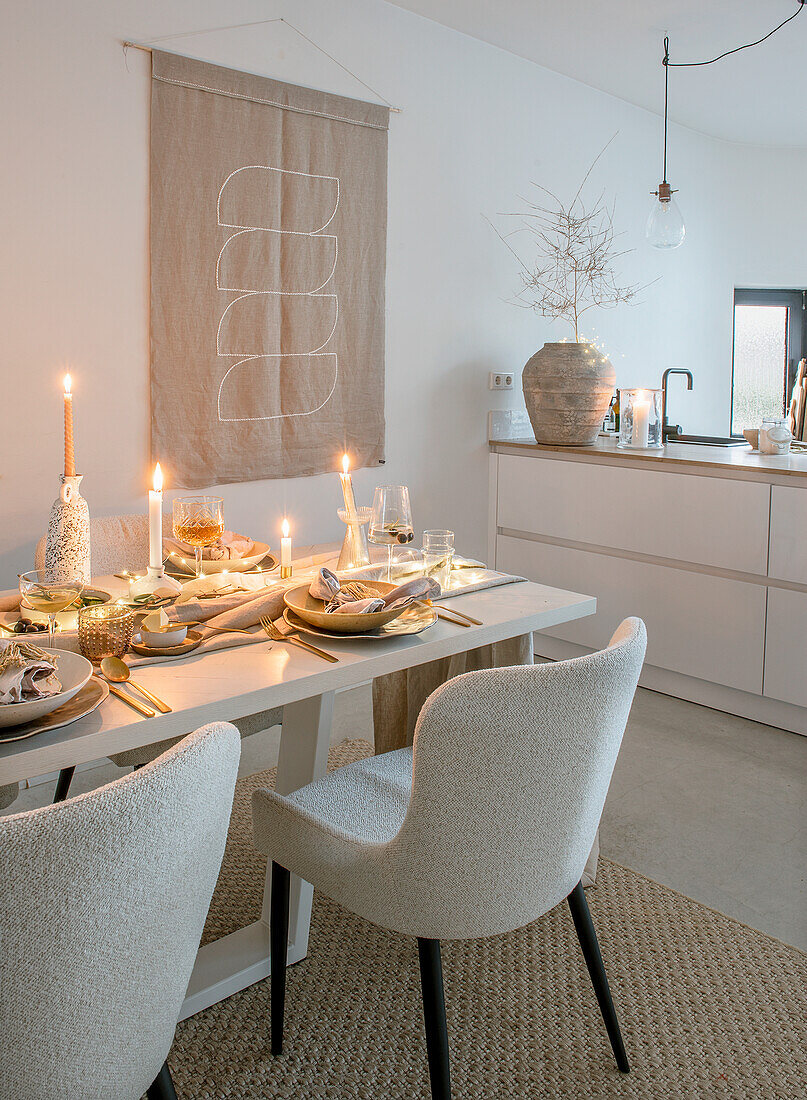 Set dining table with candles in modern, minimalist dining room