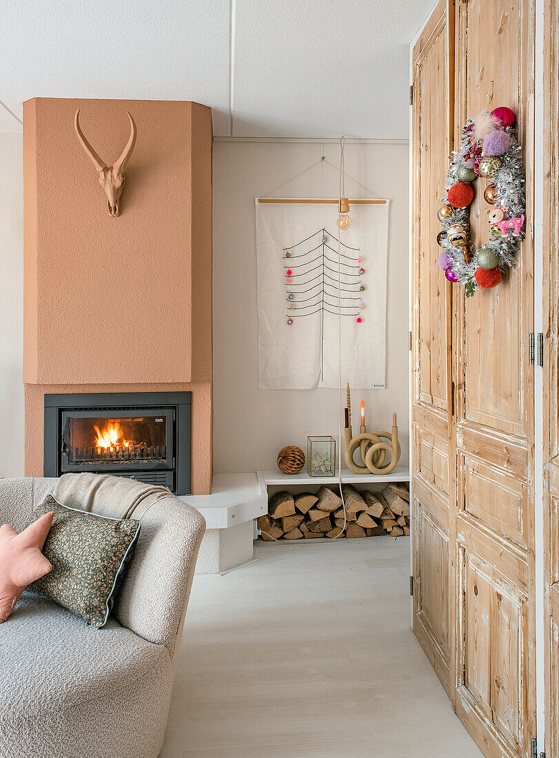 Living room with fireplace, wall decoration and rustic wooden cupboard