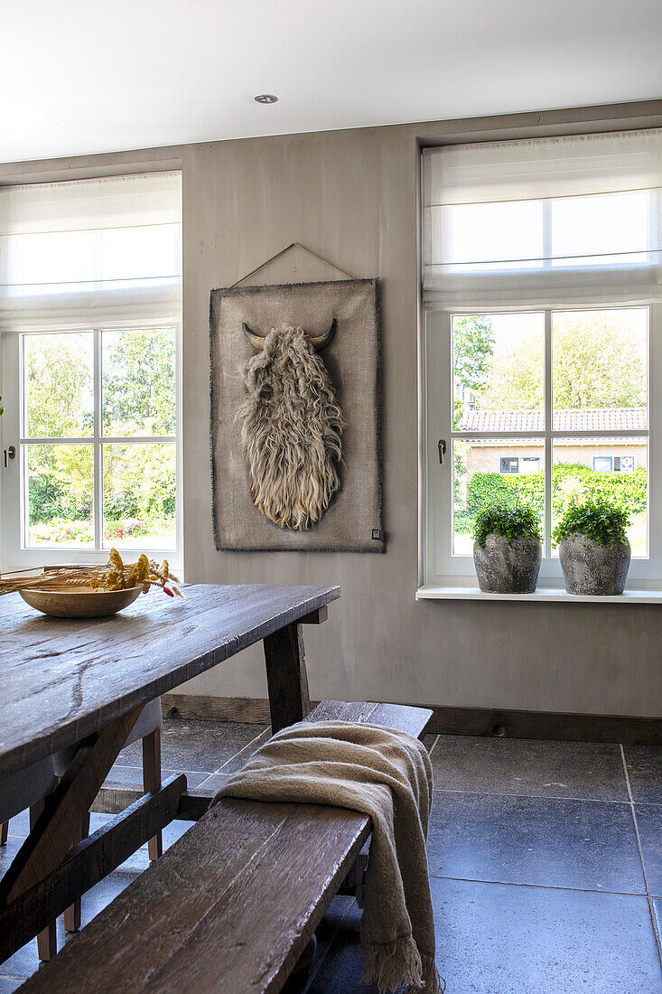 Rustic dining room with wooden table and fur wall decoration