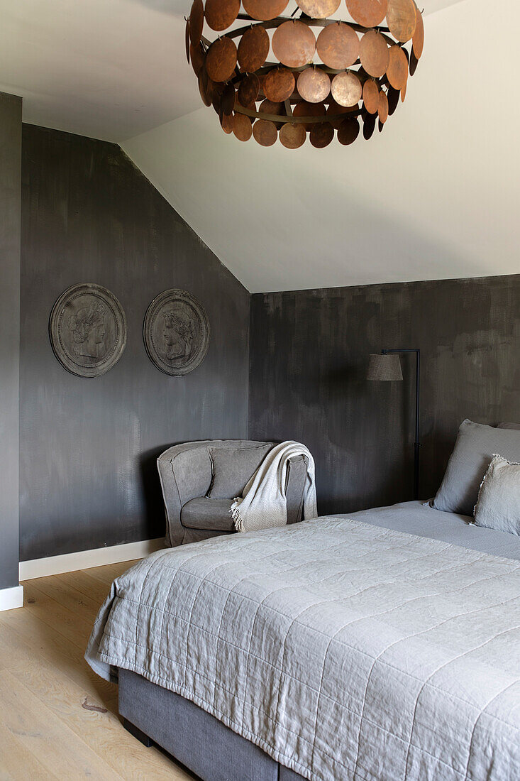 Bedroom with grey wall paint and copper lamp