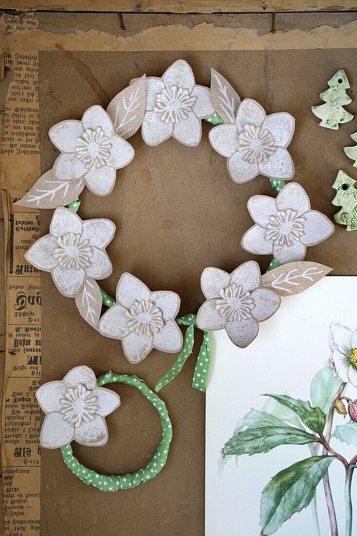 DIY spring wreath made from paper flowers and green ribbon