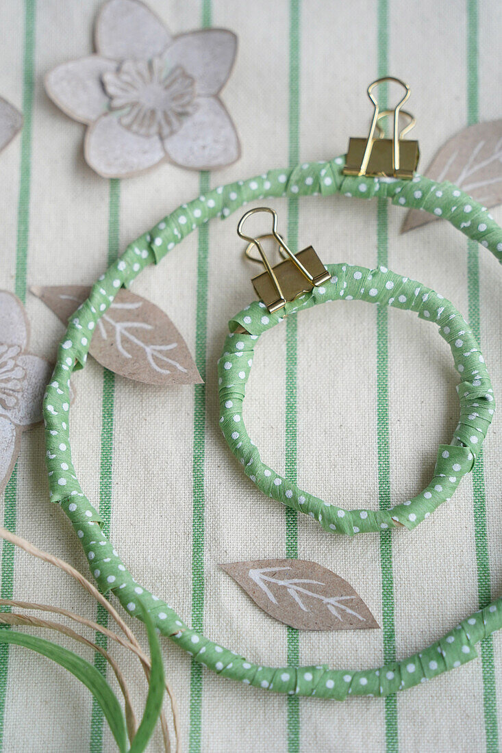 Decorative rings wrapped with ribbon, note clips and paper flower embellishment