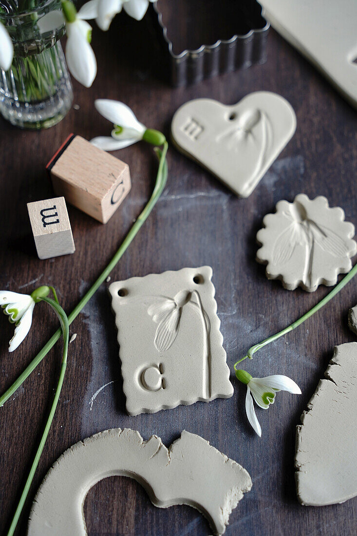 DIY clay pendant in various shapes with flowers and letters