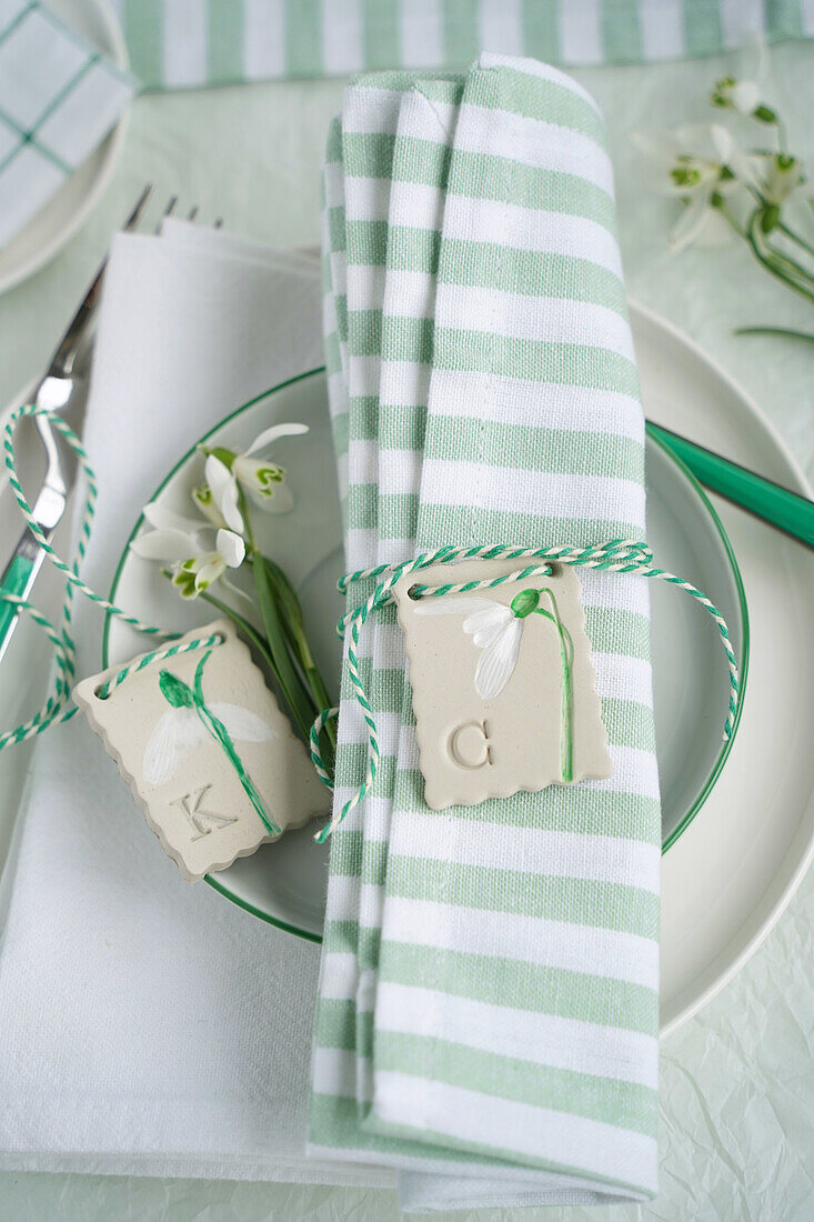 Striped fabric napkin with personalised clay pendant