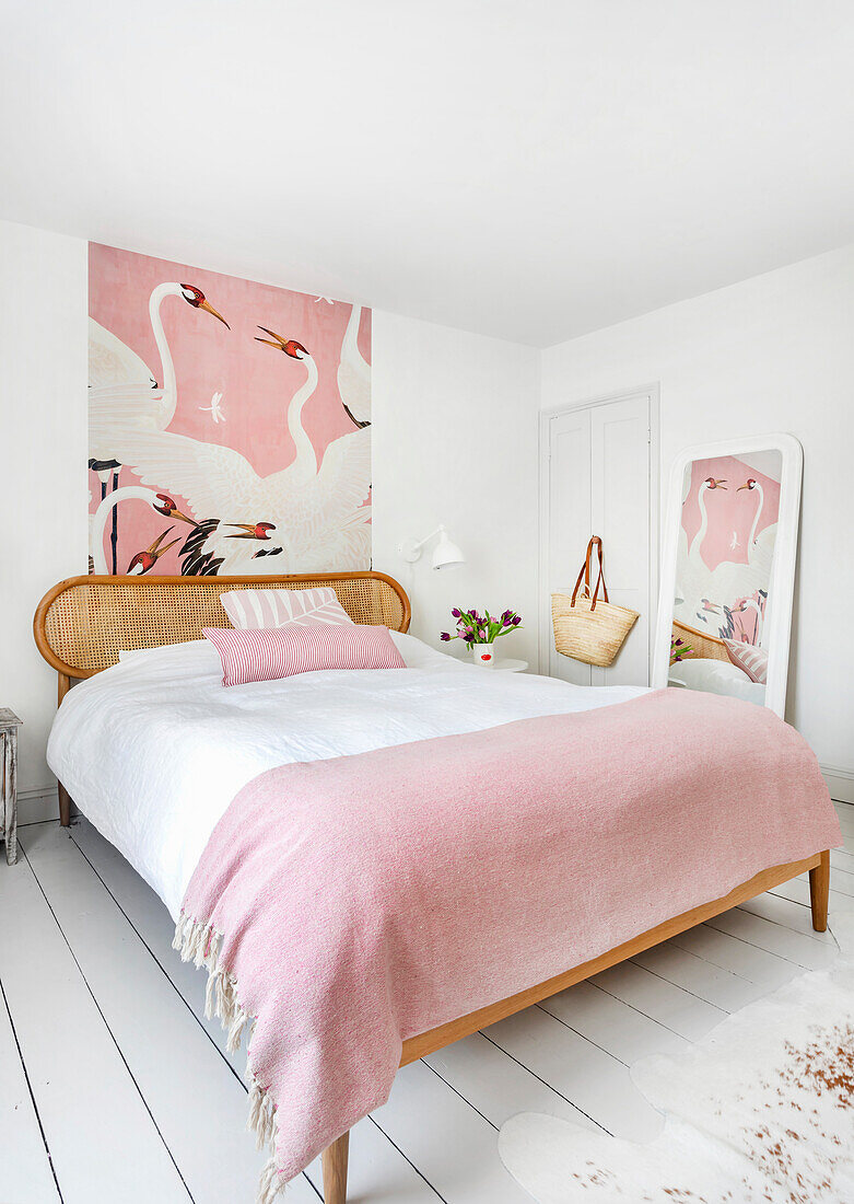 Bedroom in pink with heron wallpaper and mirror