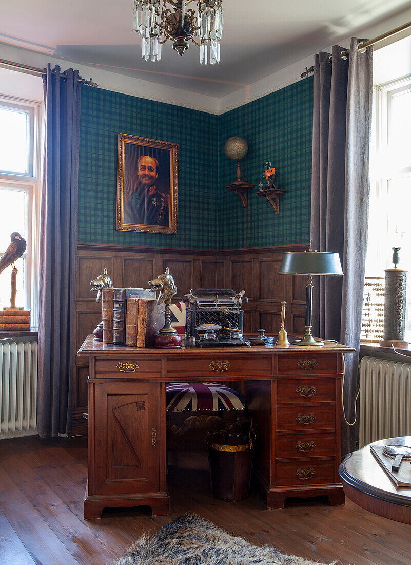 Study with patterned wallpaper and antique desk