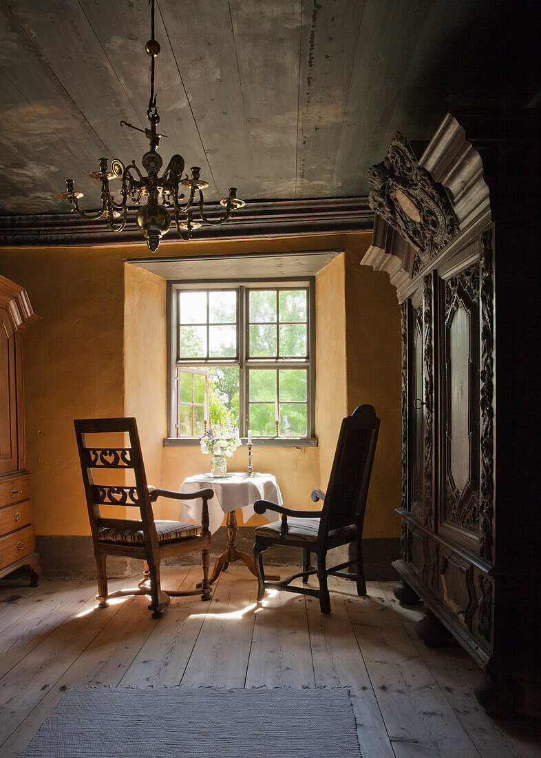 Historic living room with wooden furniture and chandelier