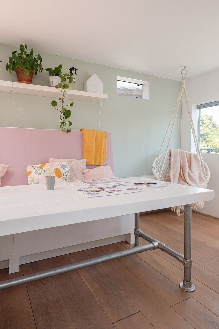 Living area with Scandinavian-style hanging chair and white table