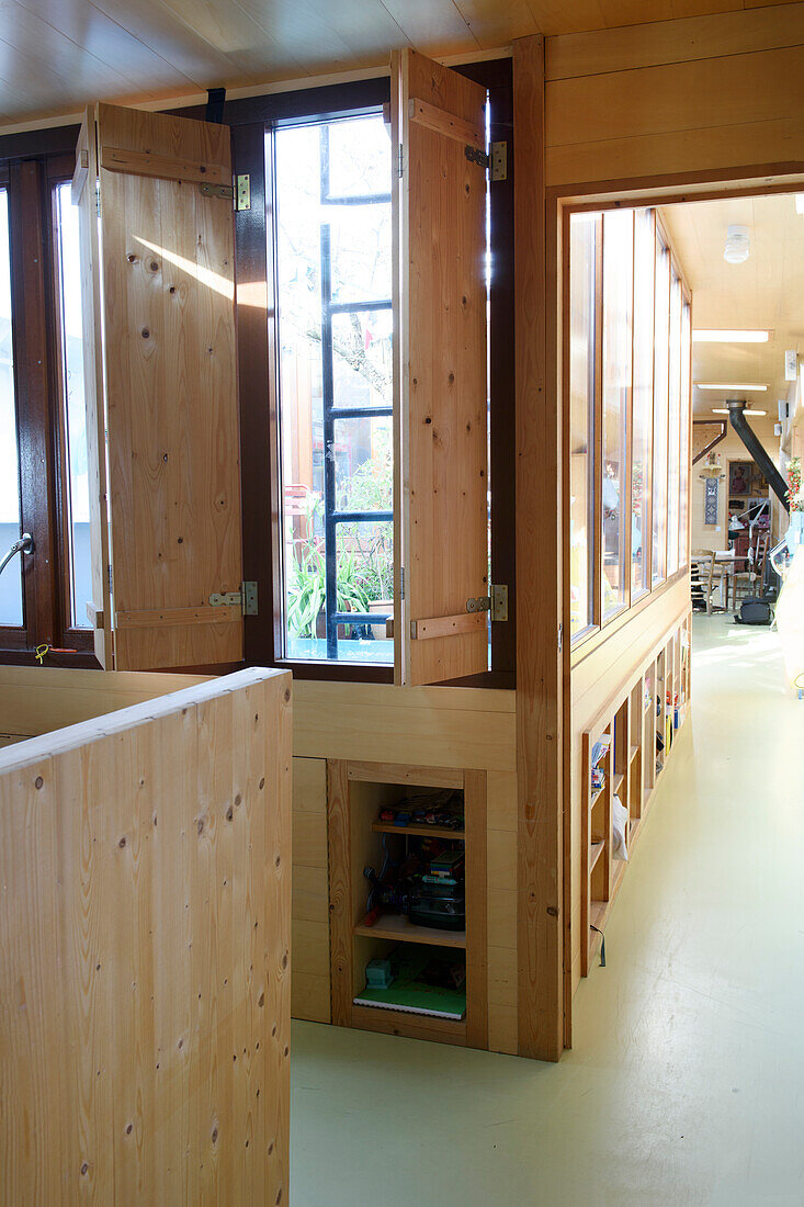 Wood-panelled hallway with fitted wardrobes and large windows