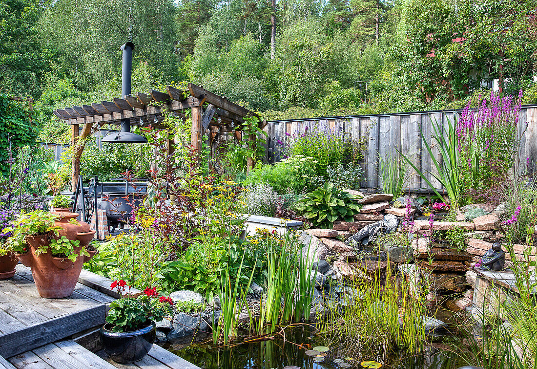 Lush garden with pergola and pond in summer