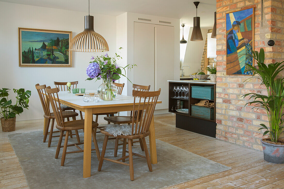 Dining area with wooden table and art on the walls