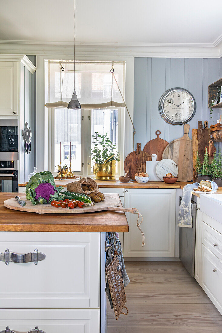 Country kitchen with wooden elements and fresh ingredients on worktop