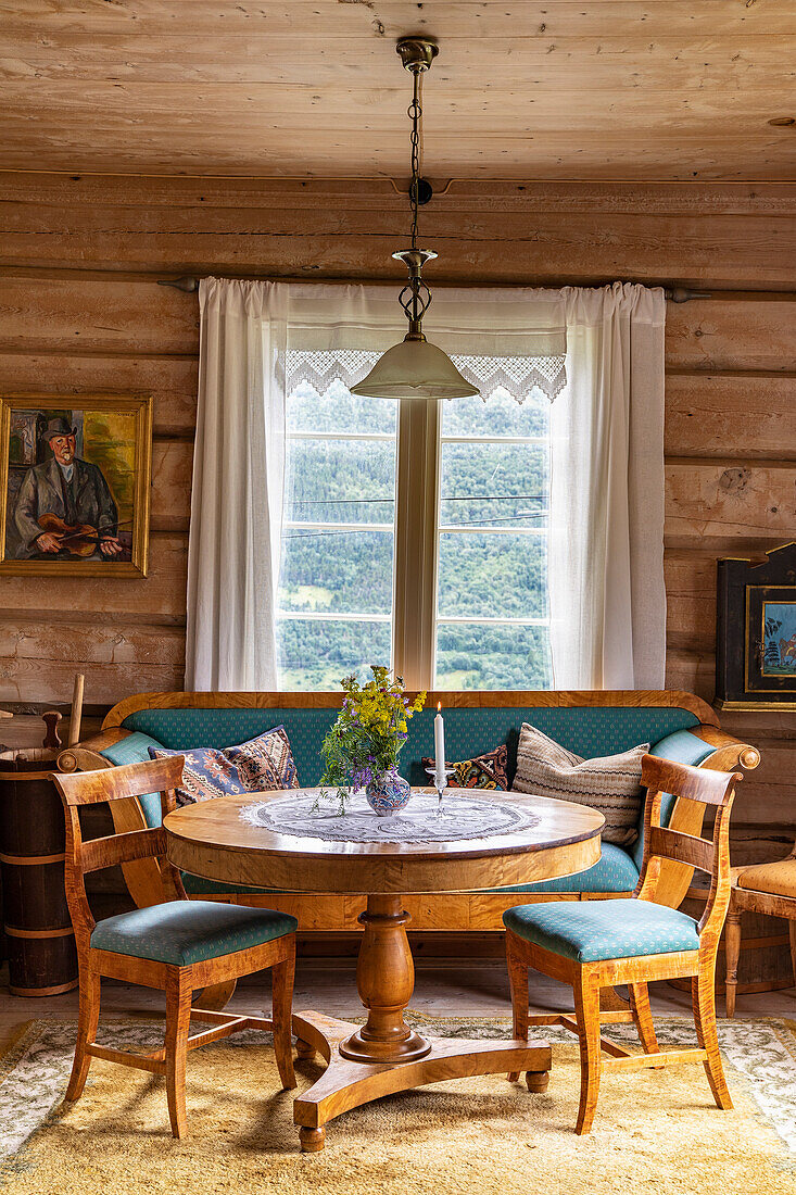 Rustic dining area with wooden furniture and corner bench in a mountain hut