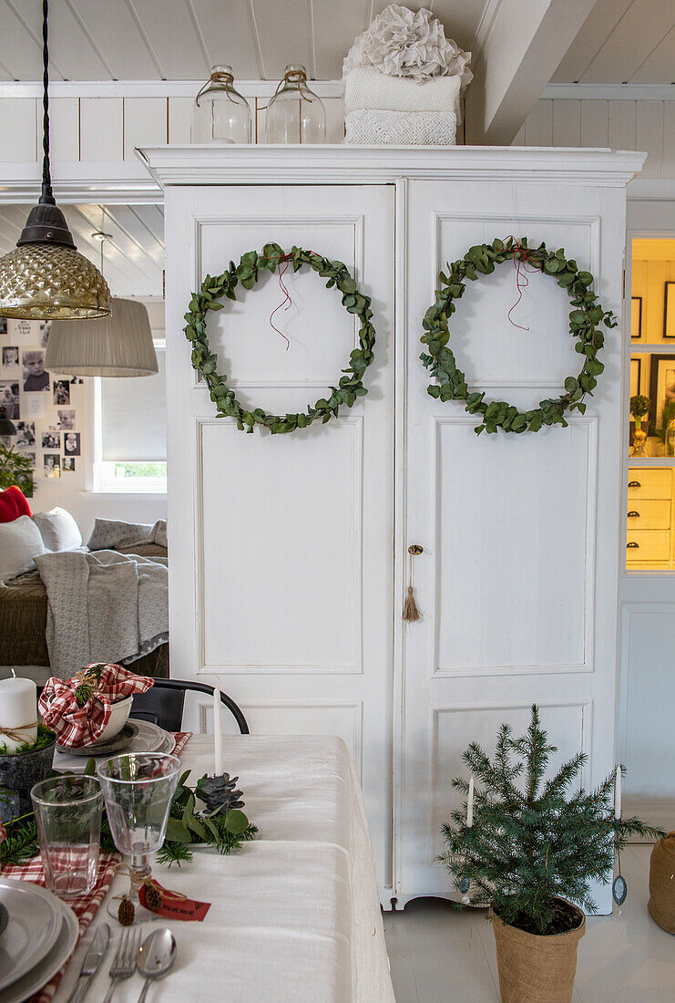 Christmas decorated cupboard doors with two fir wreaths