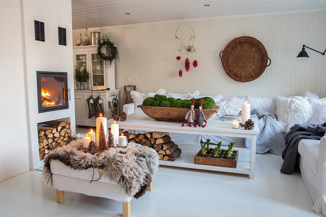 Bright living room with fireplace, wood storage and Christmas table decorations