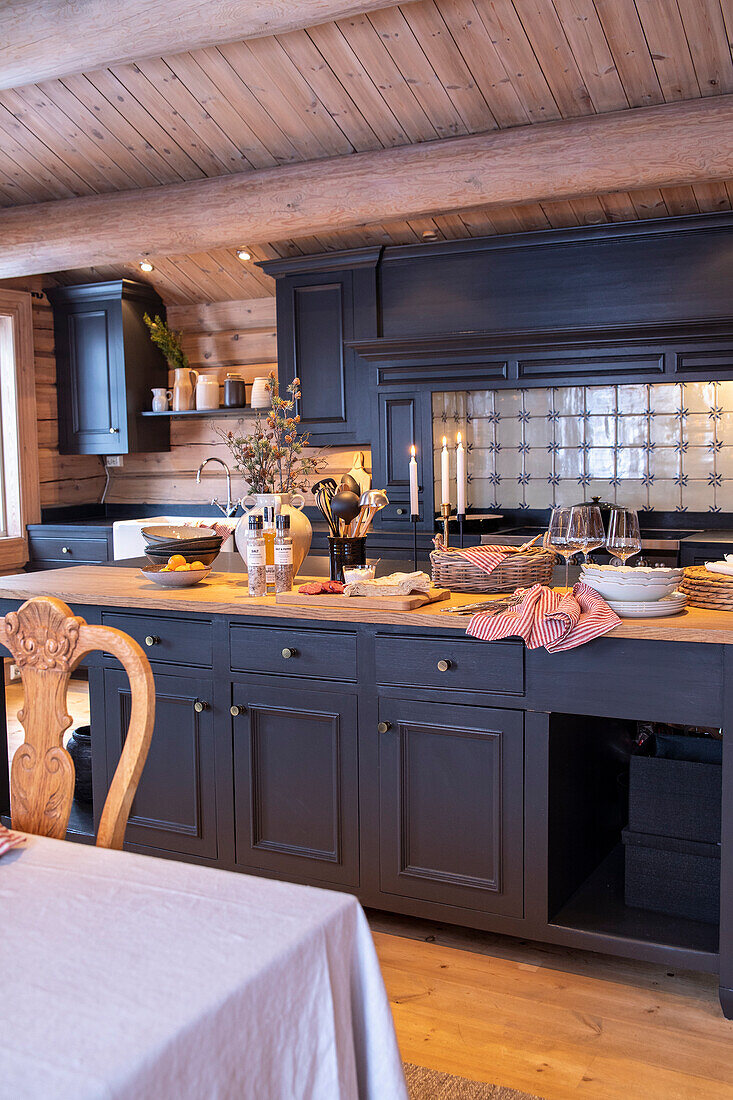 Country kitchen with dark wooden cupboards and rustic decorations