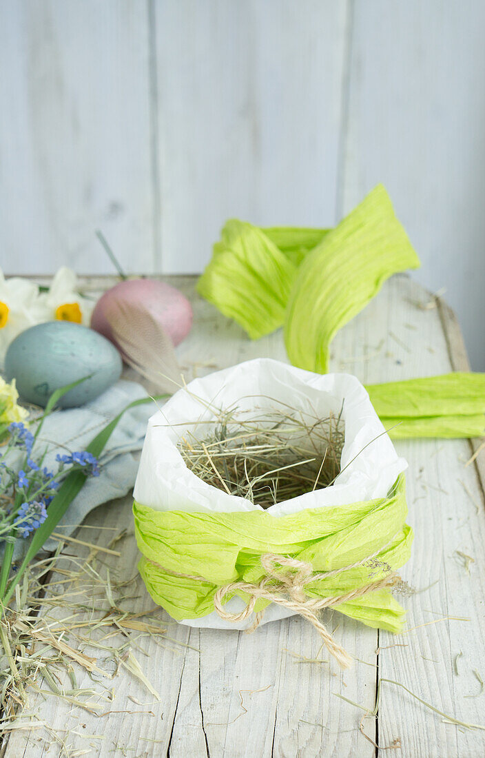 Easter nest in paper bag with hay and Easter eggs