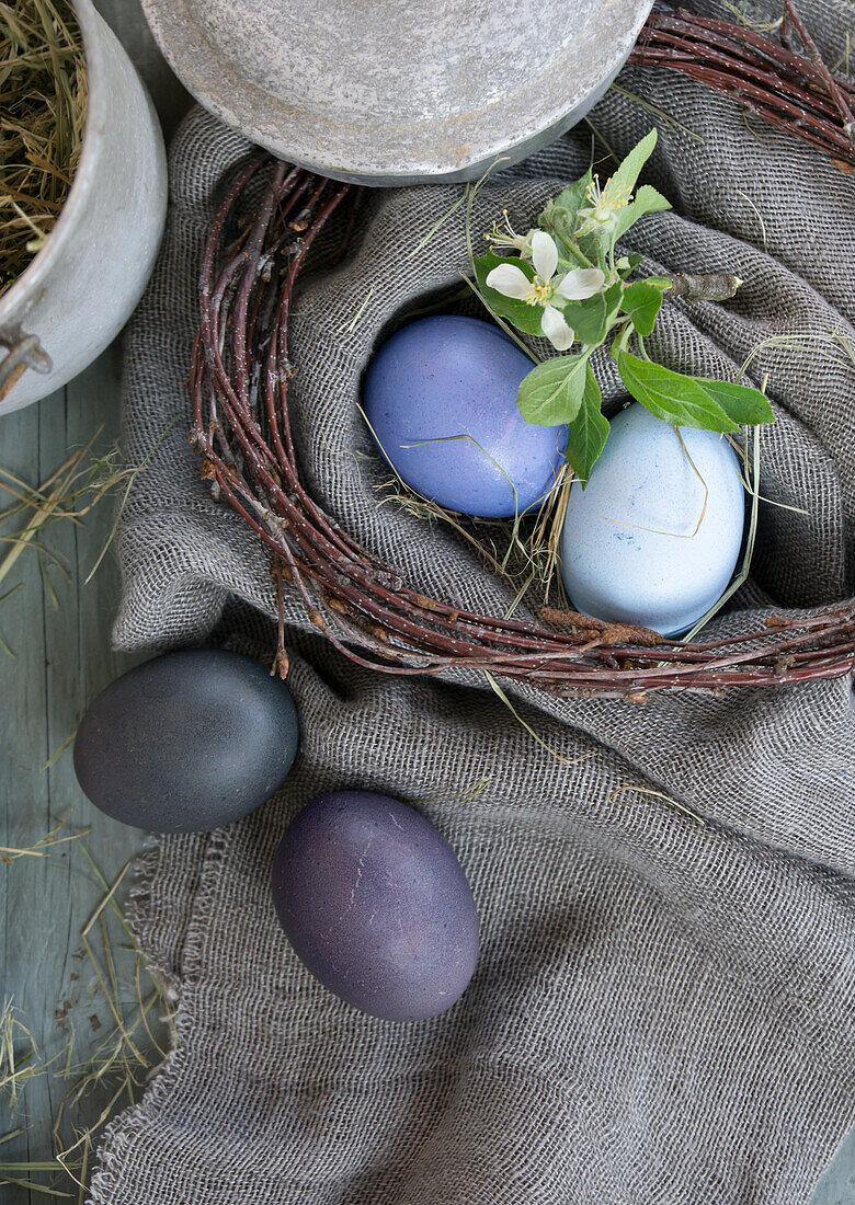 Arrangement with birch wreath and Easter eggs, dyed with red cabbage and beetroot