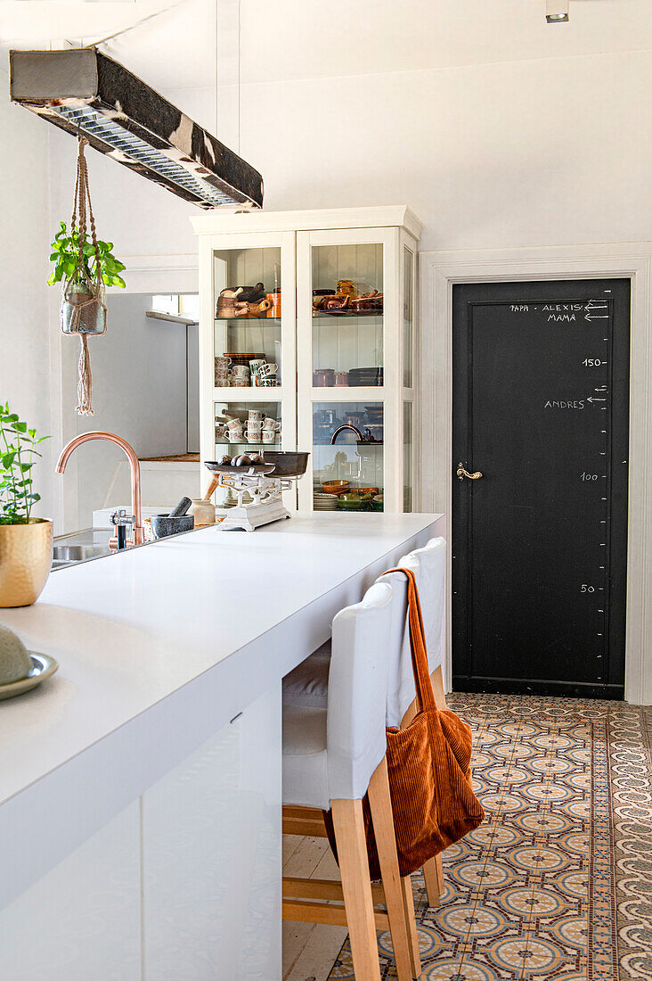 Modern kitchen with white display cabinet and patterned floor tiles