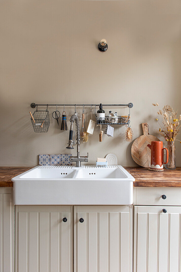 Country kitchen with ceramic sink and rustic wooden countertop