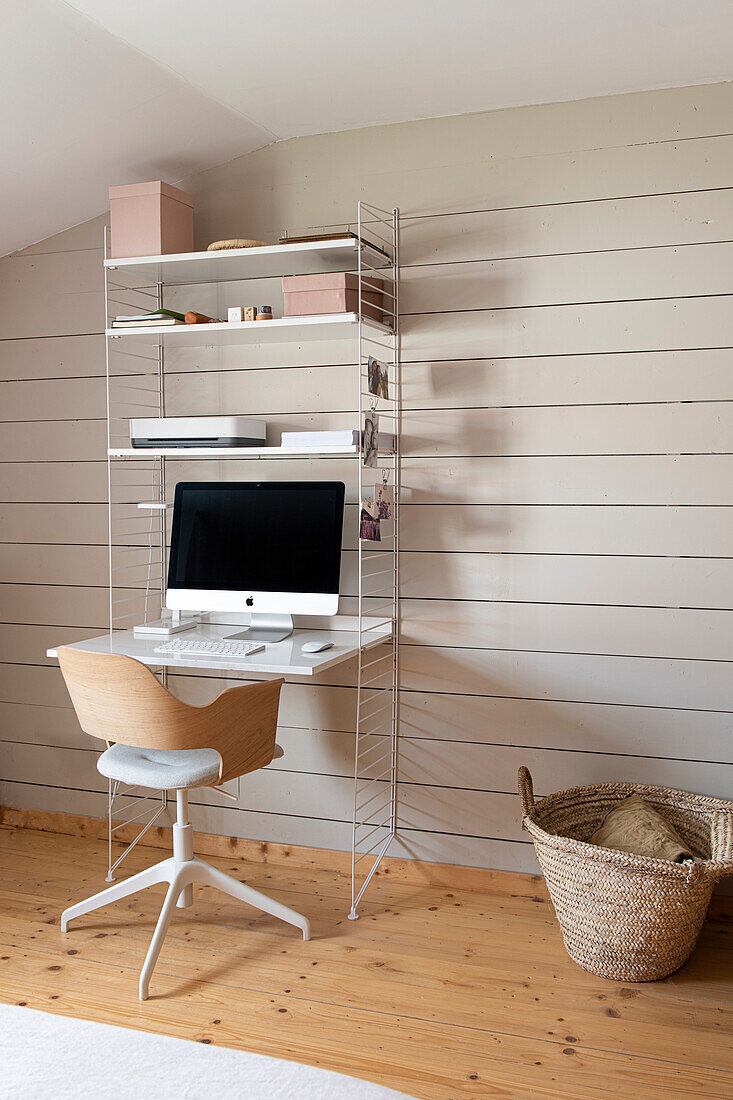 Home office corner with metal shelf and wooden desk in Scandinavian style