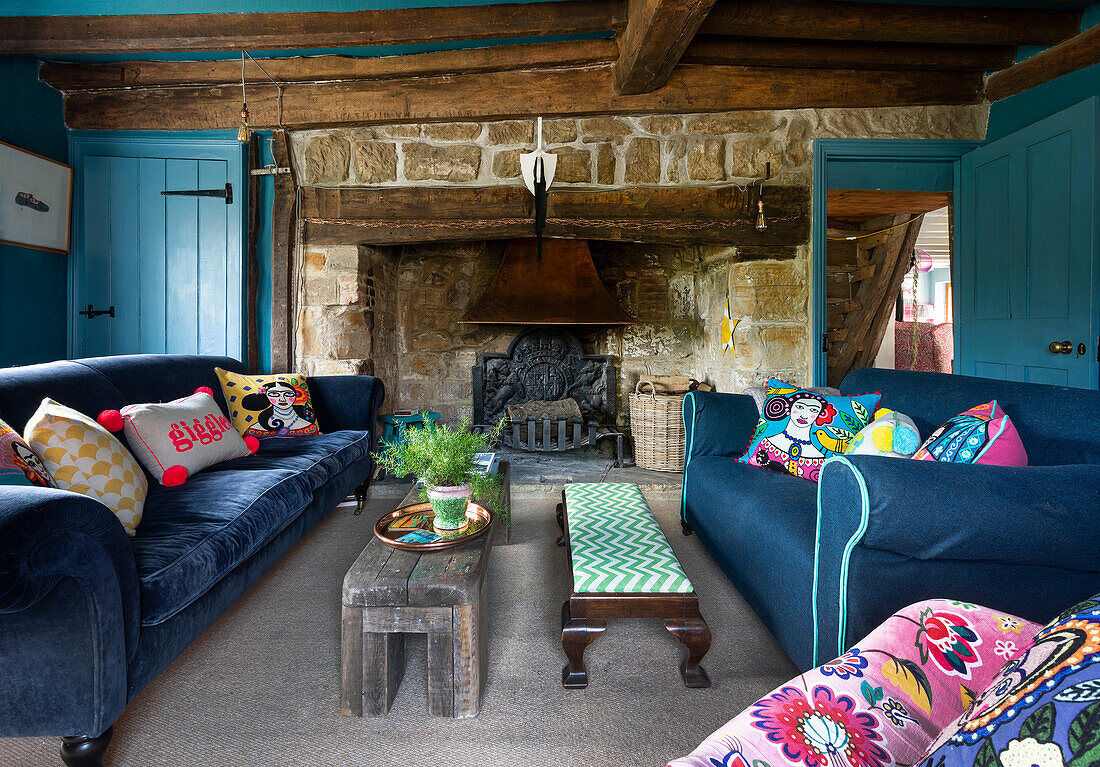 Rustic living room with fireplace and colorful throw pillows on sofas